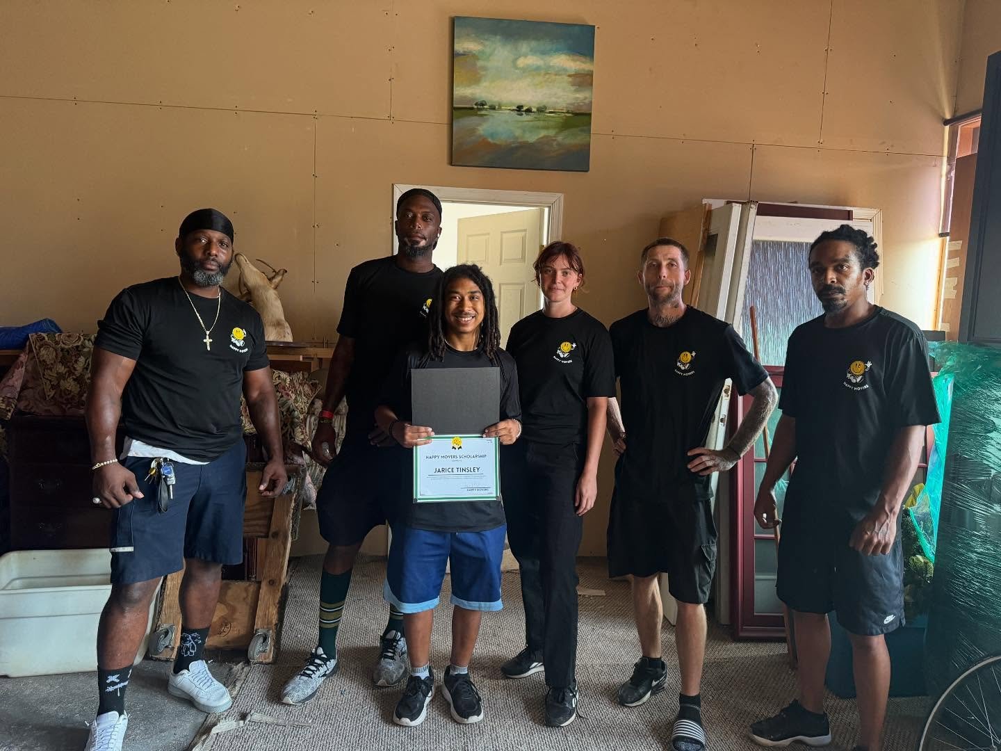 Happy Movers crew celebrating scholarship presentation